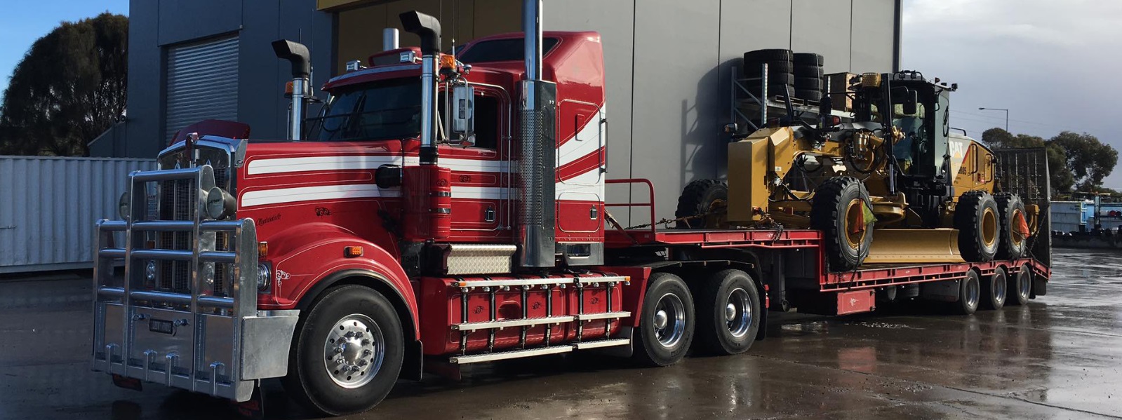 Conquest Semi truck with a small dozer loaded on the trailer