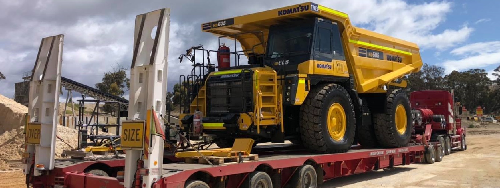 Conquest Semi truck with a small dozer loaded on the trailer