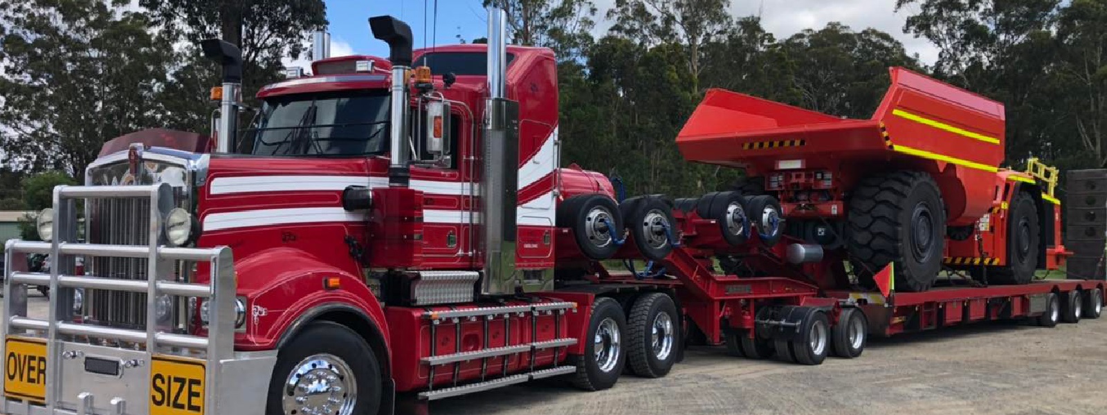 Conquest Semi truck with a small dozer loaded on the trailer