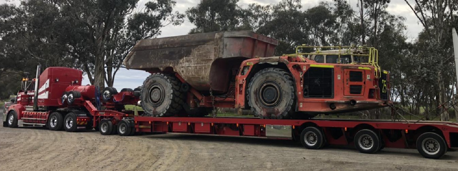 Conquest Semi truck with a small dozer loaded on the trailer