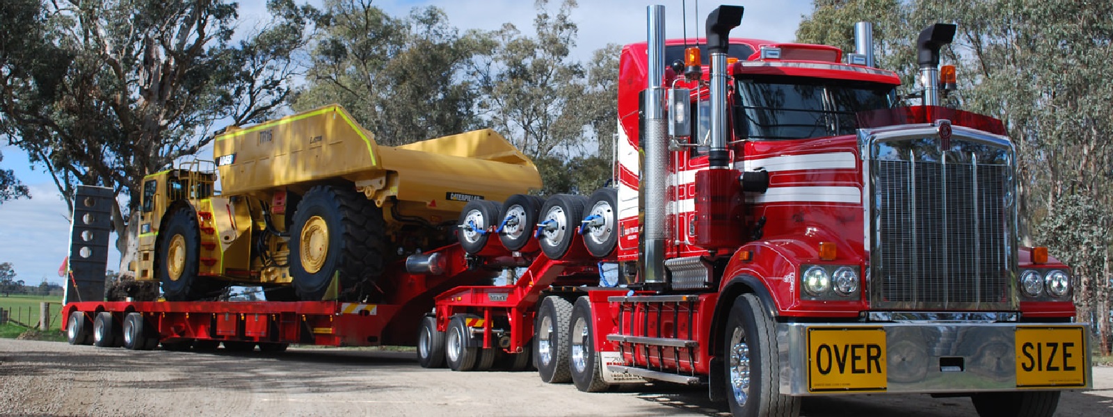 Conquest Semi truck with a small dozer loaded on the trailer