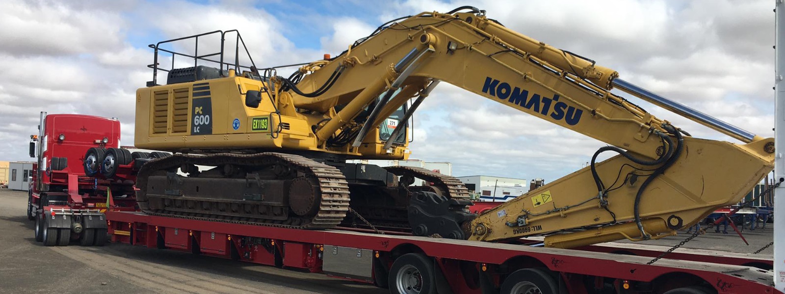 Conquest Semi truck with a small dozer loaded on the trailer