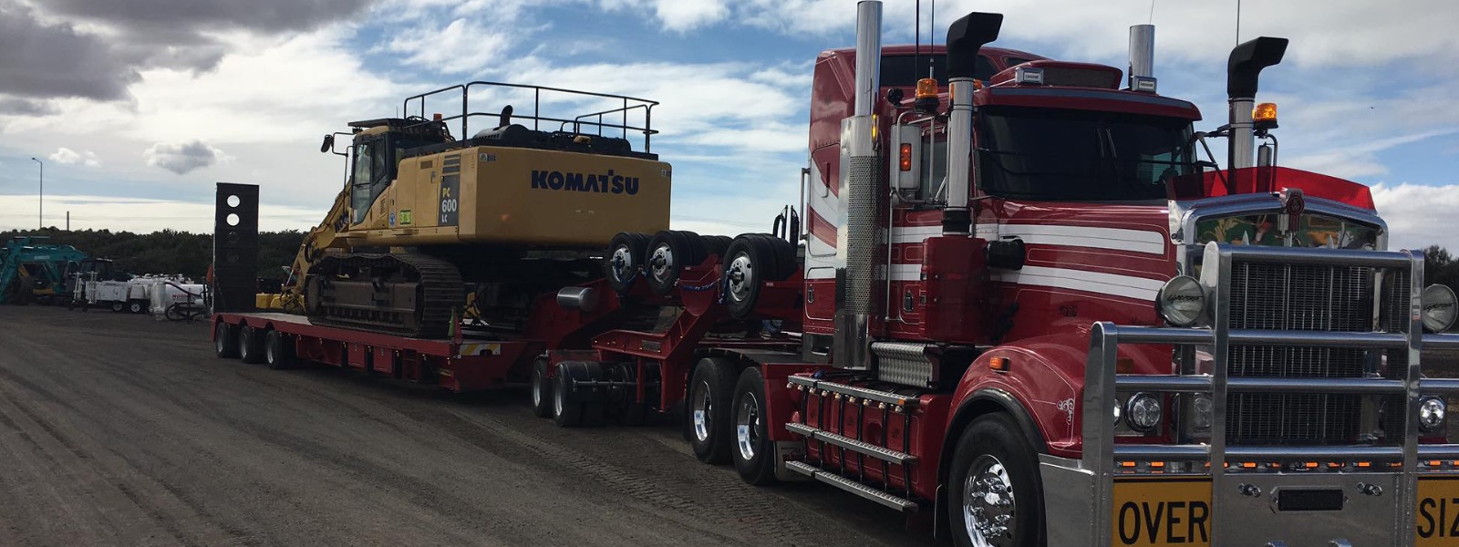 Conquest Semi truck with a small dozer loaded on the trailer